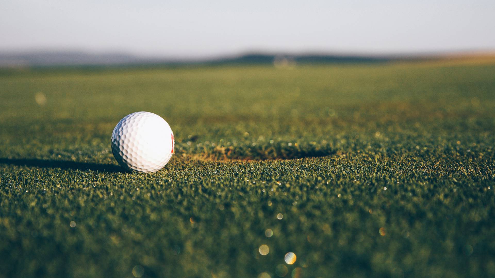 Golfball liegt auf Rasen