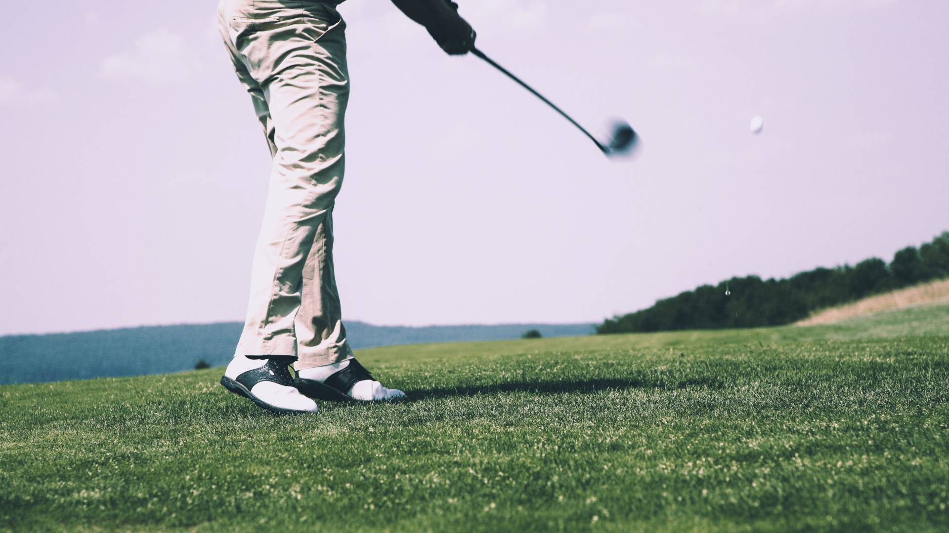 Golfer teeing off on golf course